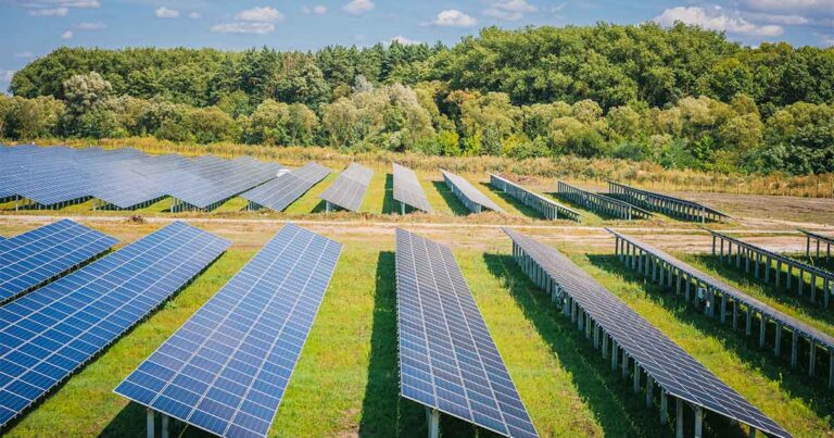 Side view of solar panel rows facing the sun on the right